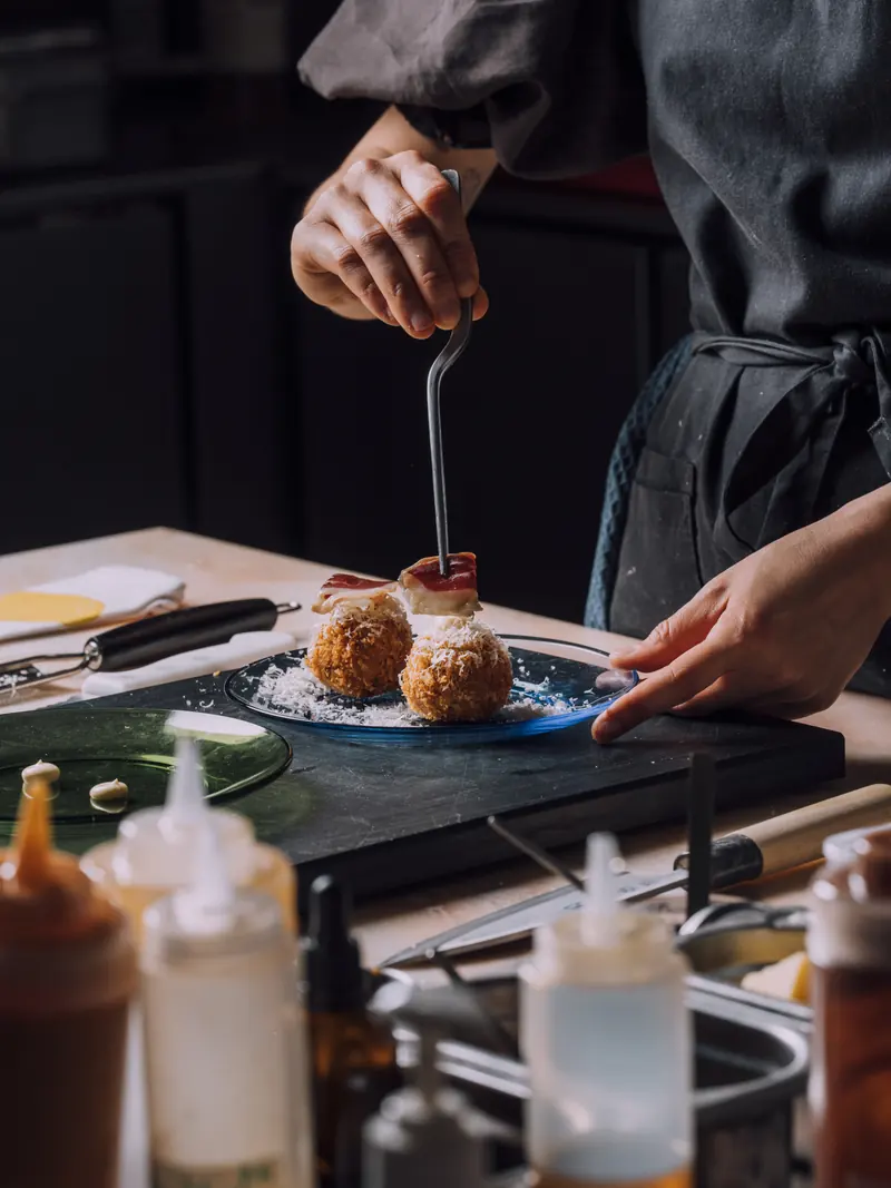 Duck rice croquettes on a green plate
