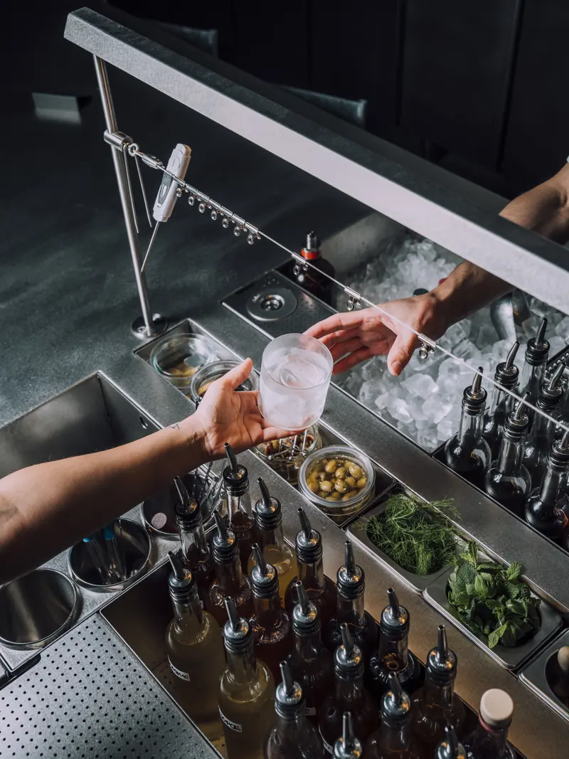Bottles and fresh herbs at the bar station